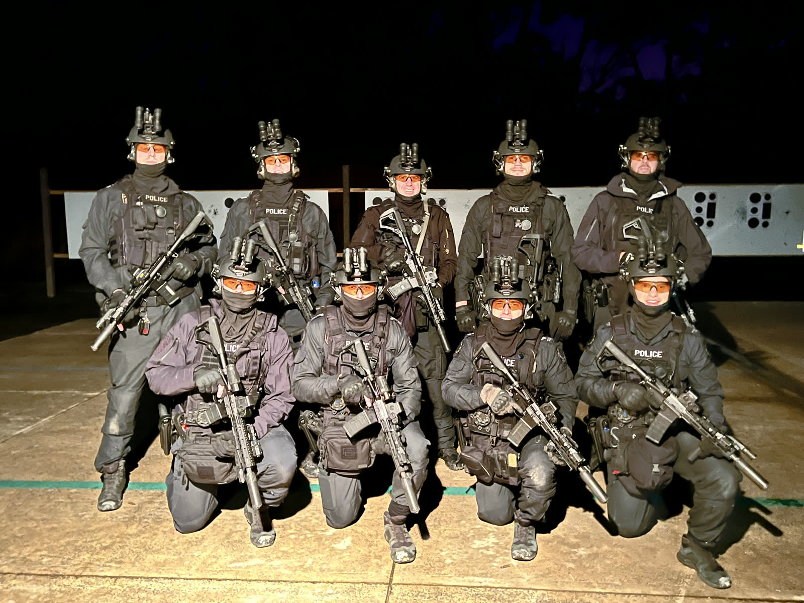 A police tactical team at night, faces covered